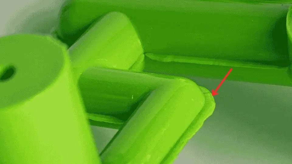 An image showing extra material seen along parting lines due to a poor mold seal. 