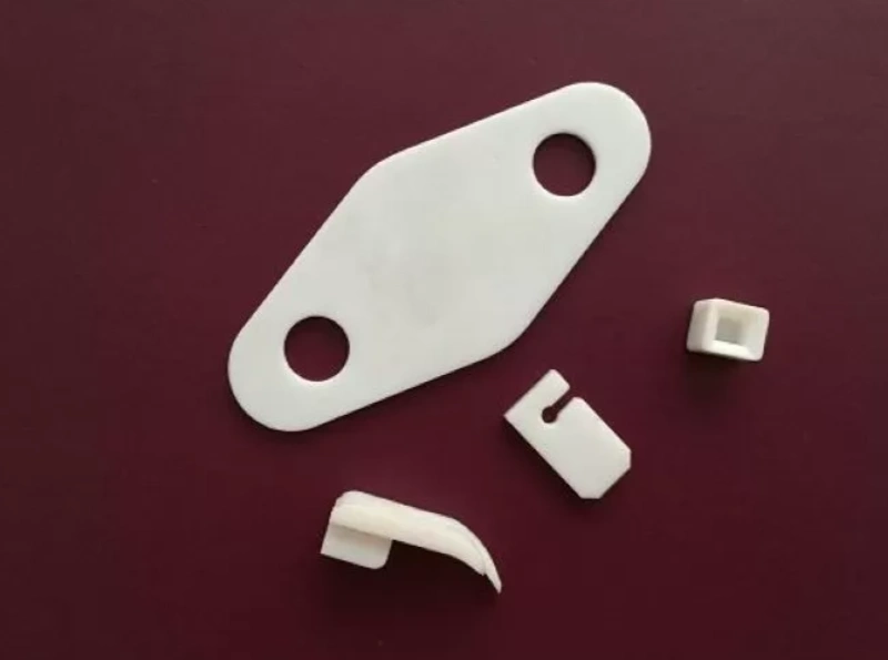 Several designs and sizes of red and grey PPS plastic gears