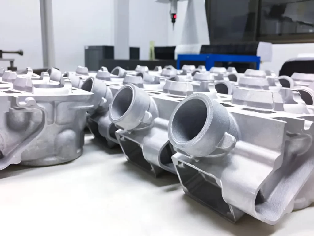 Neatly arranged aluminum automotive parts set for dimensional inspection.