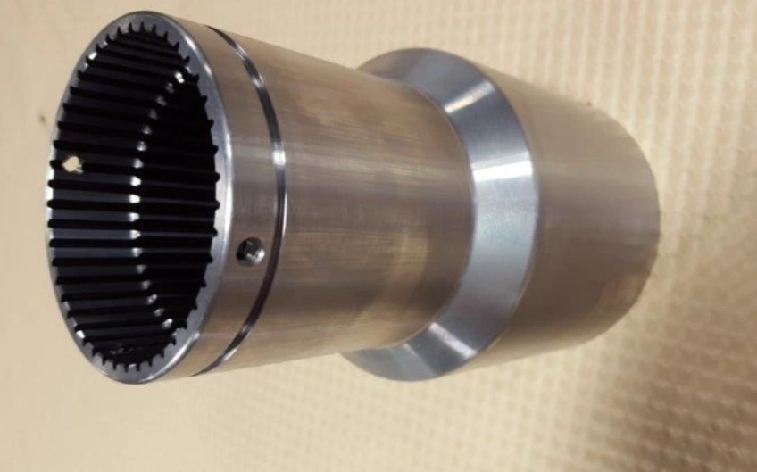 Image of a metal shaft of varying diameter sections with internal splines on one end
