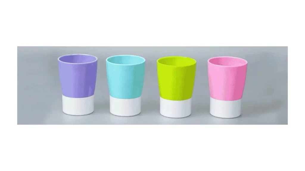 Multiple two-shot molded products in various colors arranged in a neat line.