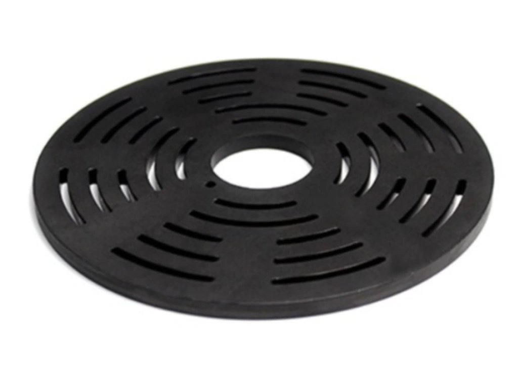 A round, black PEEK valve plate with radial slotted openings and a central mounting hole.
