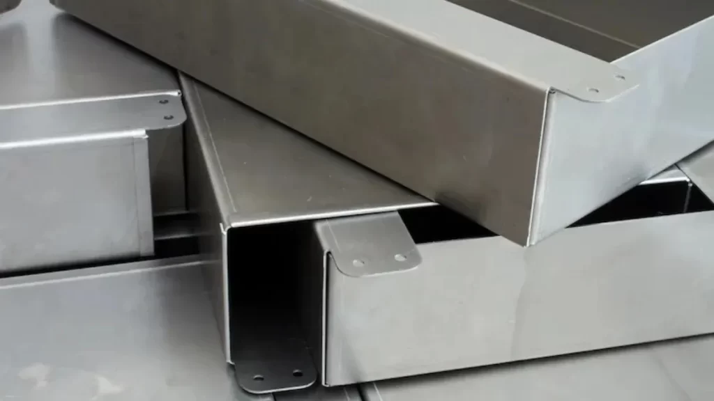 The image displays bent and shaped metal pieces joined together. It showcases detailed sheet metal fabrication work.