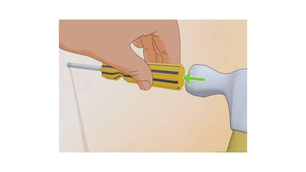 An illustration showing the process of making a slot in a broken tap for screwdriver use. The slot helps in turning the tap to remove it.
