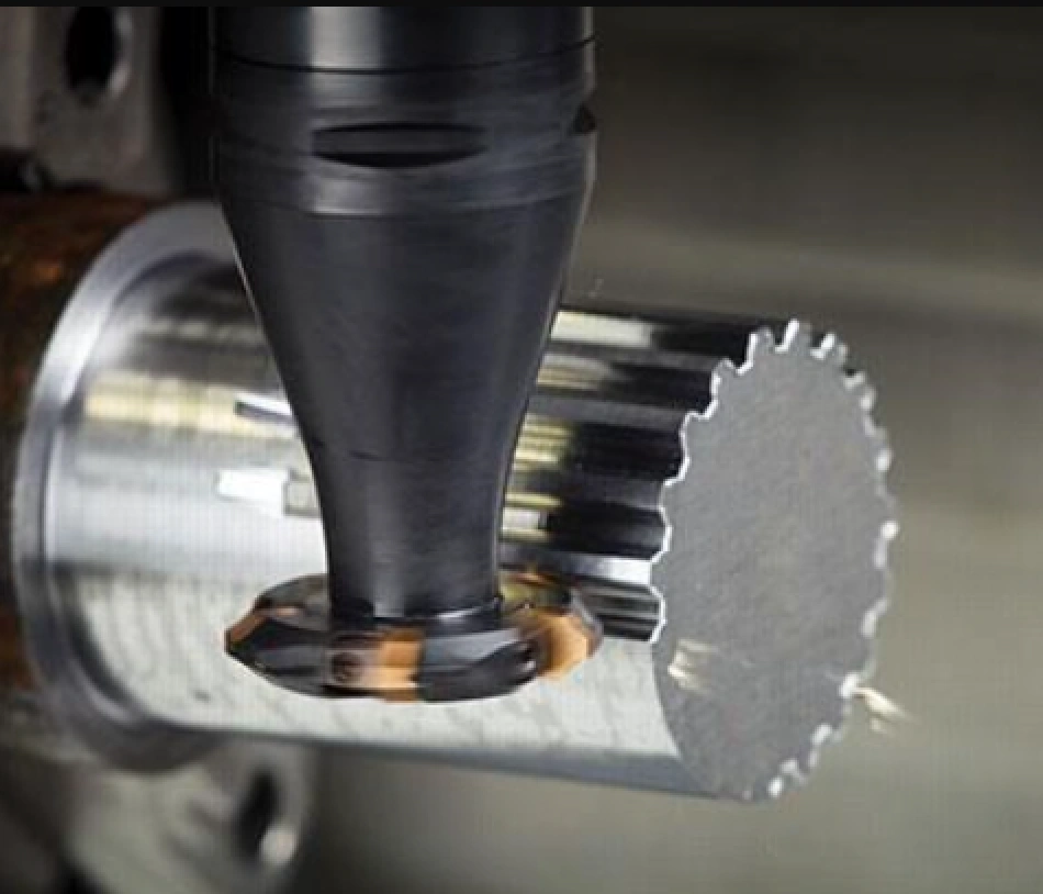 A CNC side milling tool machining a shaft to produce splines