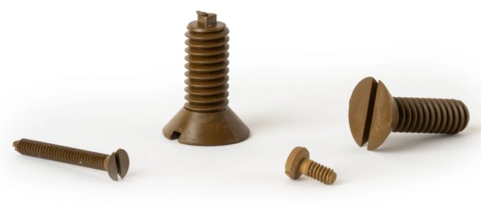 Brown Torlon® fasteners of different designs and sizes on a white background