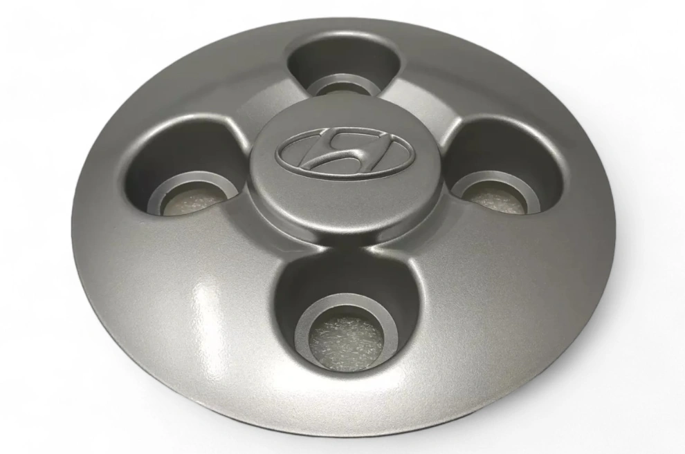 A closeup image of a Honda vehicle wheel center cap on a white background