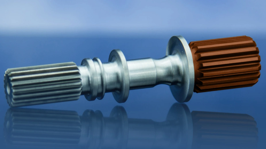 An image of a brown and grey shaft with splines on both ends used in the defence industry