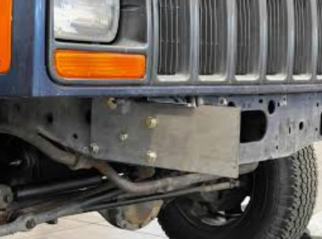 A closeup image of a Jeep XJ’s front bumper mounting brackets