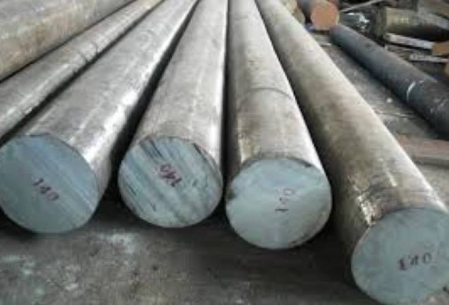 Several marked round bars of 4140 steel on a cemented surface