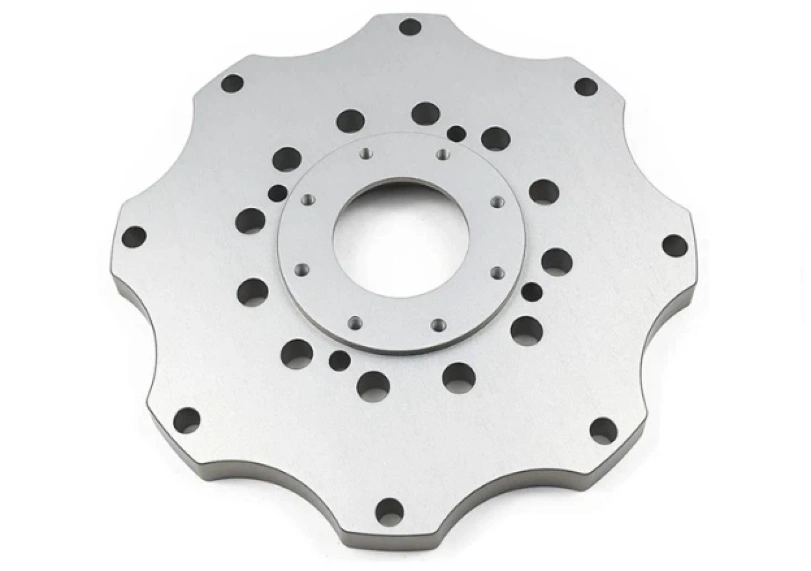 A precisely machined 7075 material circular plate with concentric holes and curves