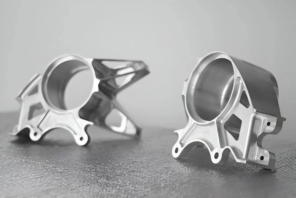 A set of automotive milled parts displayed on a flat surface, showing clean and precise finishes.