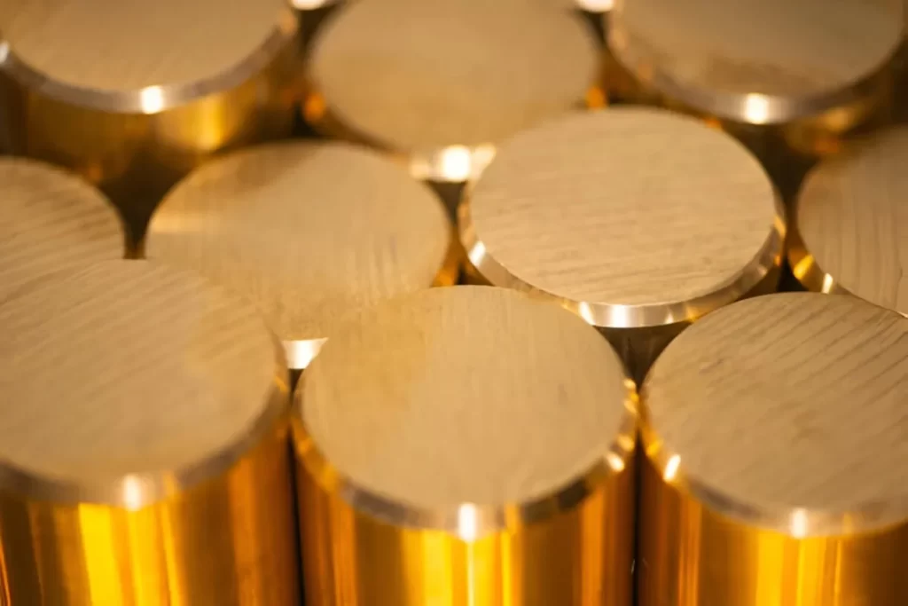 Close-up view of brass bars, highlighting their polished surfaces.