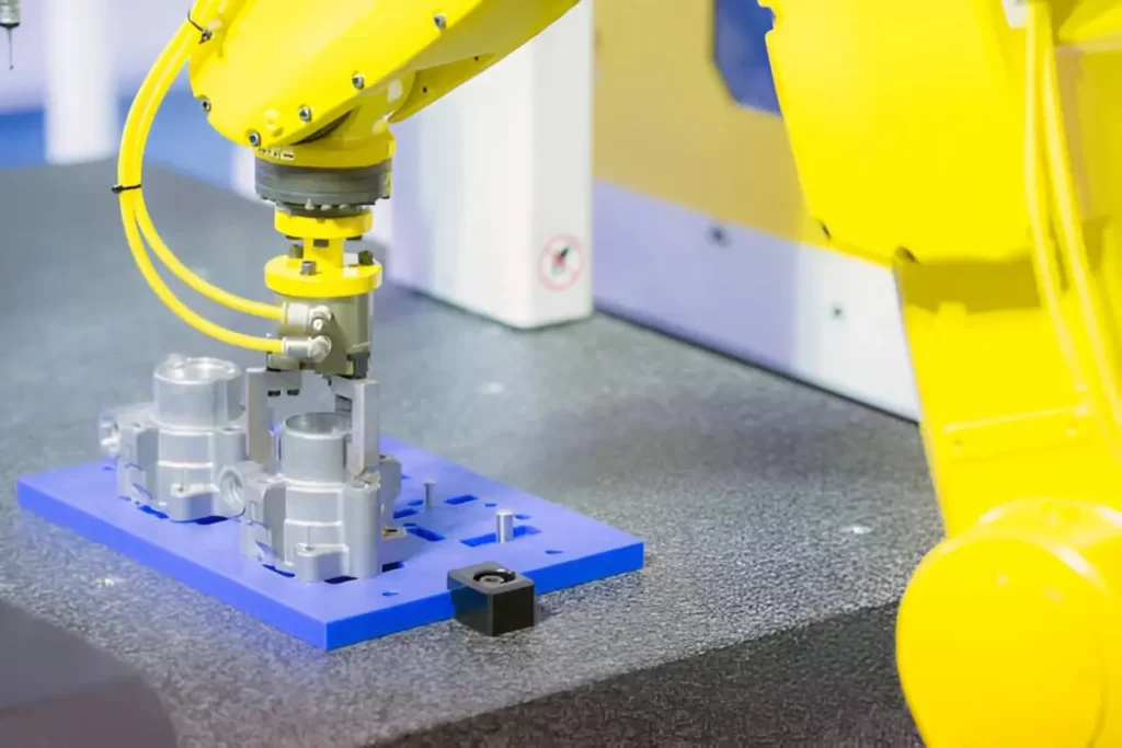 A CNC robot picking up parts during an automated process.