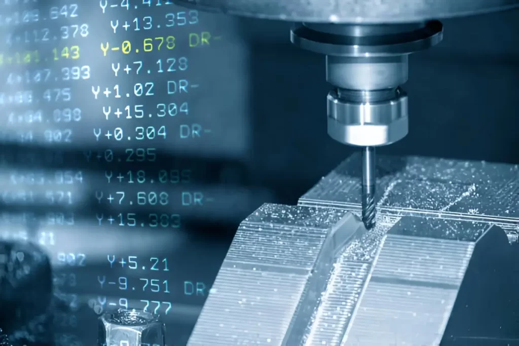 A metal part is being CNC milled on one side, while a screen showing live G-code runs in parallel. The image captures both the machining process and the precision programming behind it.
