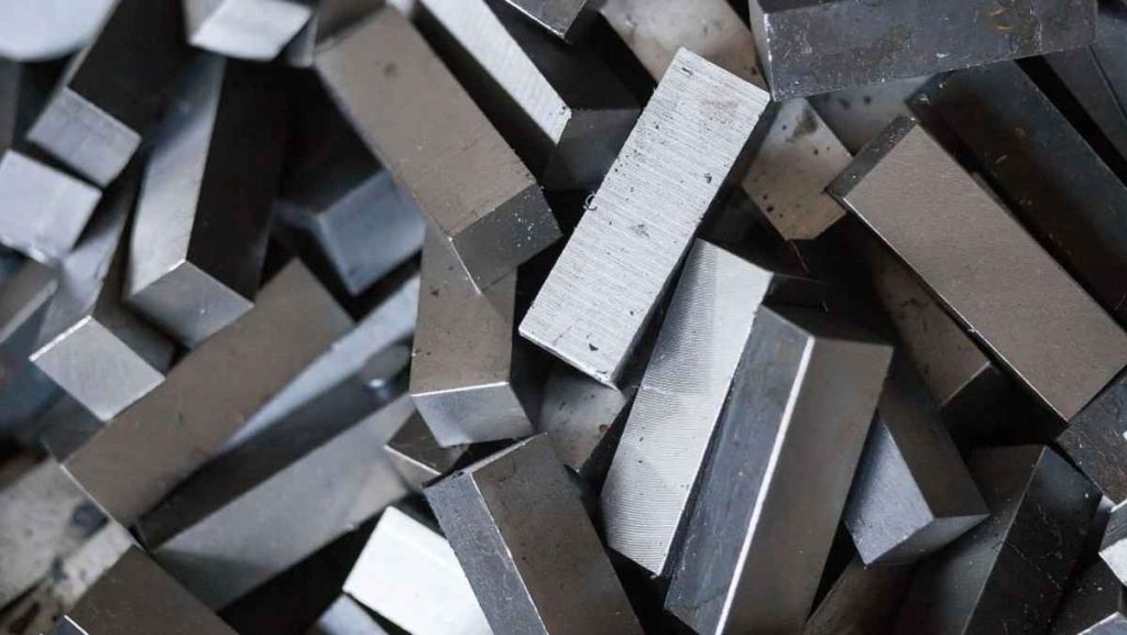 A pile of various rectangular and square metal bars.