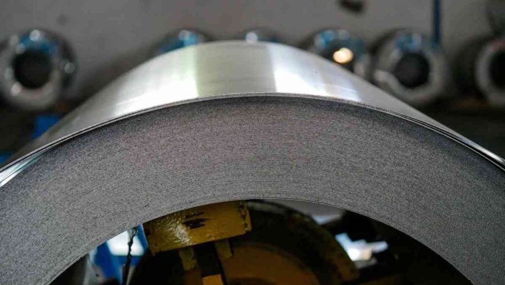 Large roll of coiled HSLA steel sheet, showing its layered edges and smooth surface.