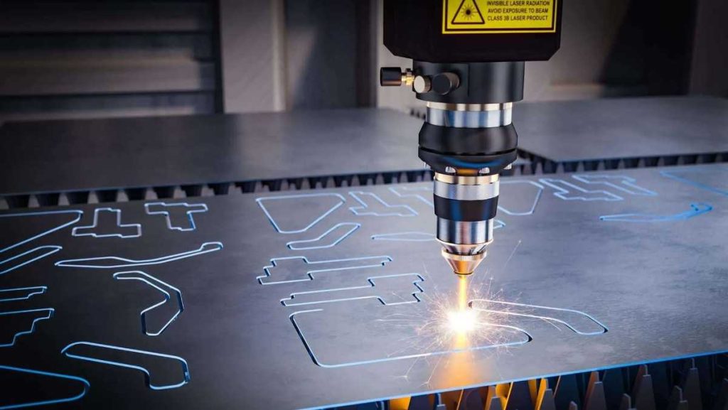 Close-up of a laser cutting machine actively cutting intricate shapes out of a metal sheet.