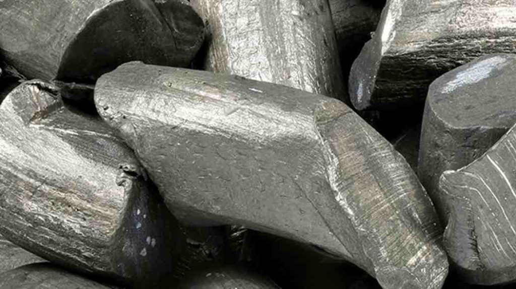 Several dark grey, irregularly shaped chunks of lithium metal.