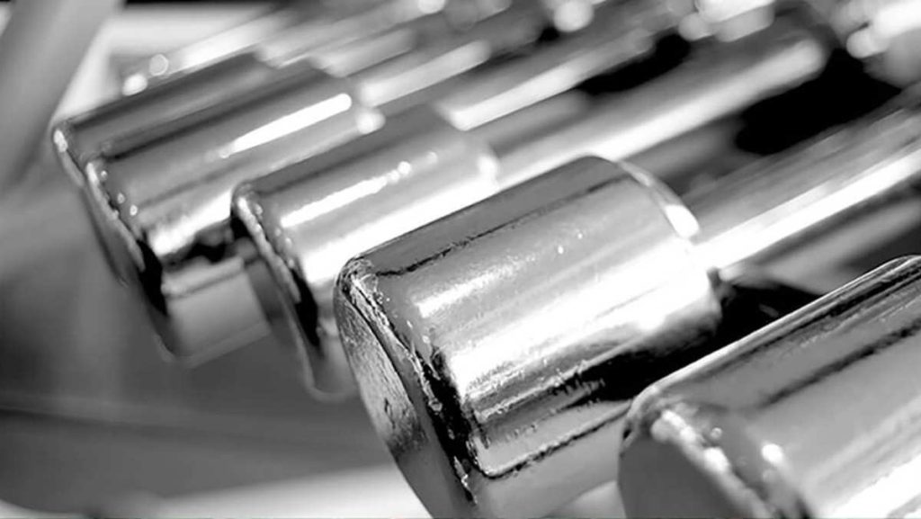 Close-up of several shiny, silver-colored titanium alloy rods.