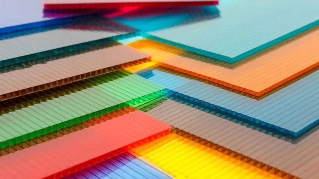 Stack of colorful, translucent corrugated polycarbonate sheets.