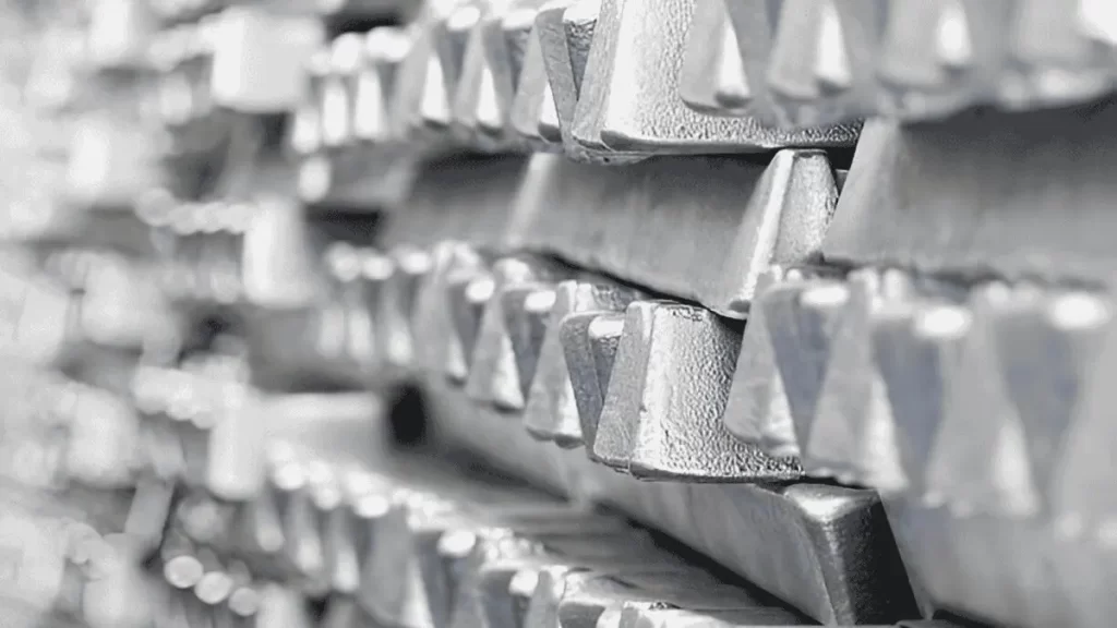 Neatly arranged raw aluminum bars stacked side by side.
