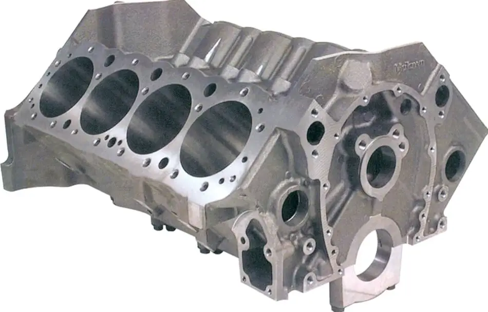 An image of a cast iron engine block showing cylinder holes and fastener holes of different sizes 