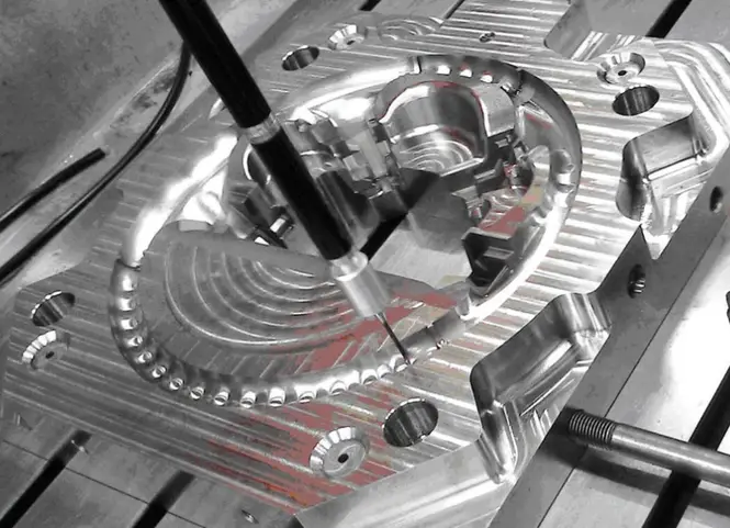 High-precision CNC-machining of a complex 4140 steel part with a coordinate measuring probe for dimensional inspection
