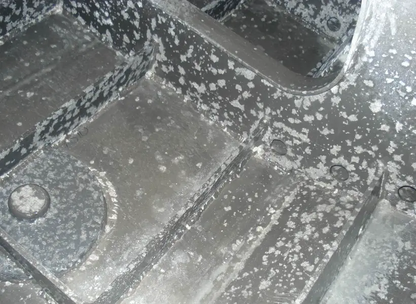 An image of a corroded aluminum alloy sheet with one rivet and several ribs