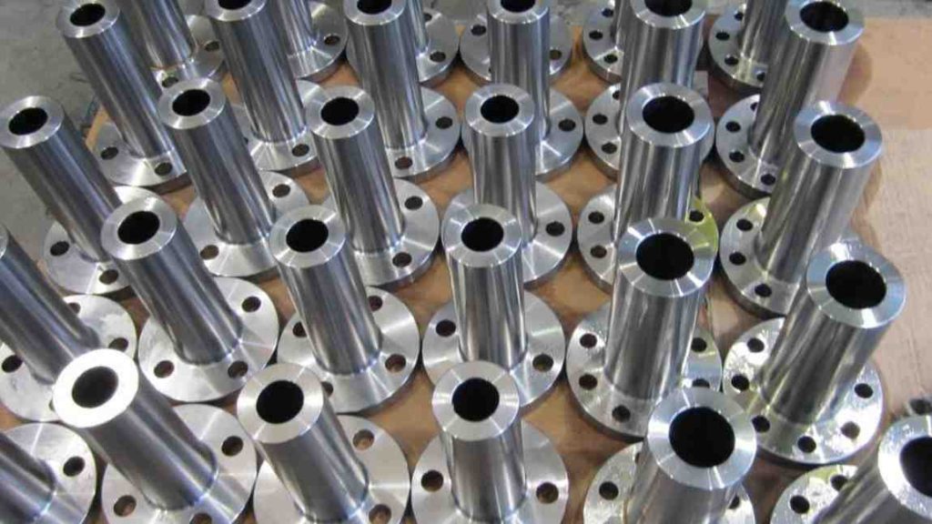 A Stack of numerous shiny metal pipes or tubes with drilled holes.