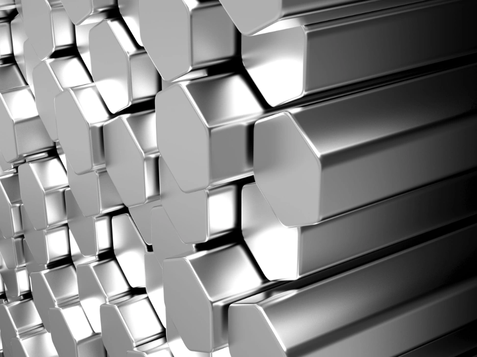 An image of stacked polished stainless steel hexagonal bars in close-up view 