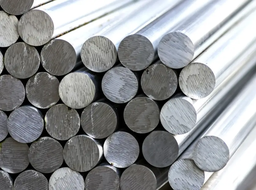 A closeup image of stacked round bars of tool steel 