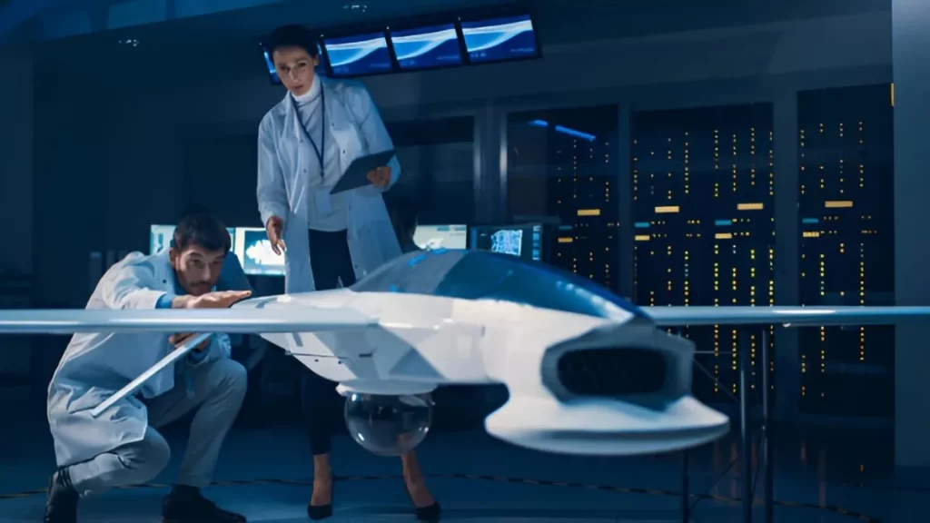 Two professionals evaluating a small aircraft model.