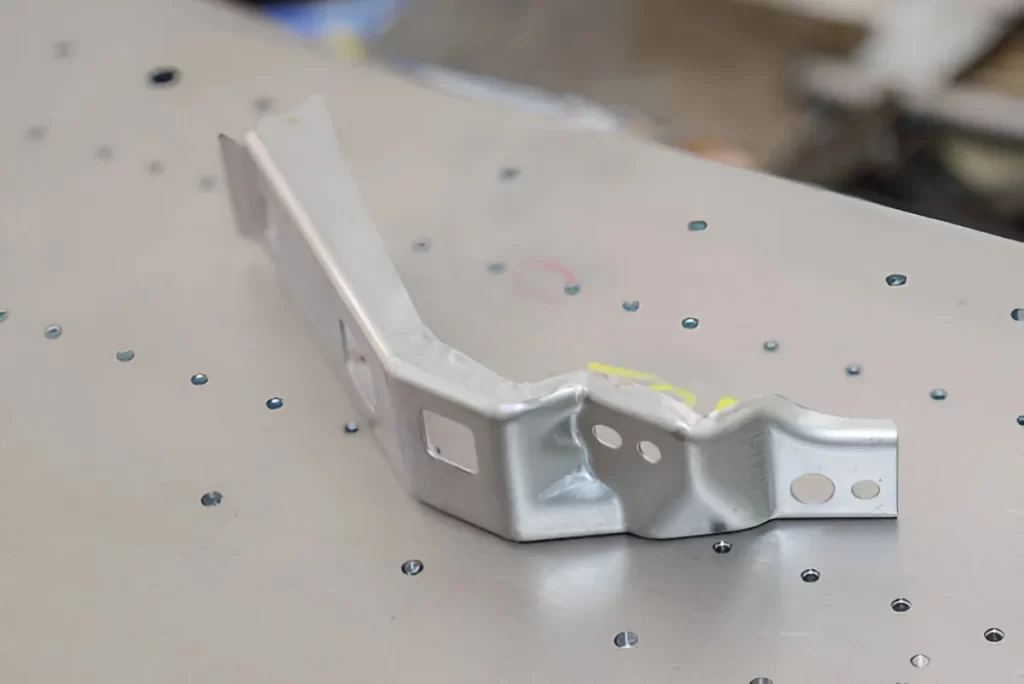 Close-up image of a bent aluminum part showing smooth curves and clean edges.