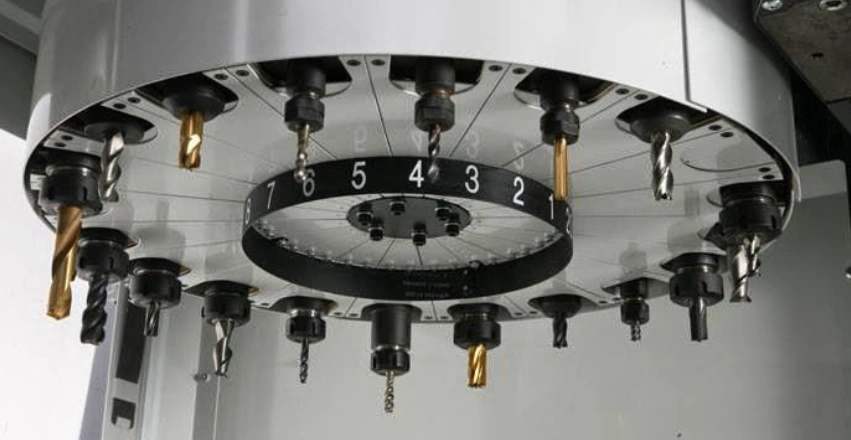 Vertical Machining Center tool changer with downward-facing tools arranged in a numbered circular disc carousel