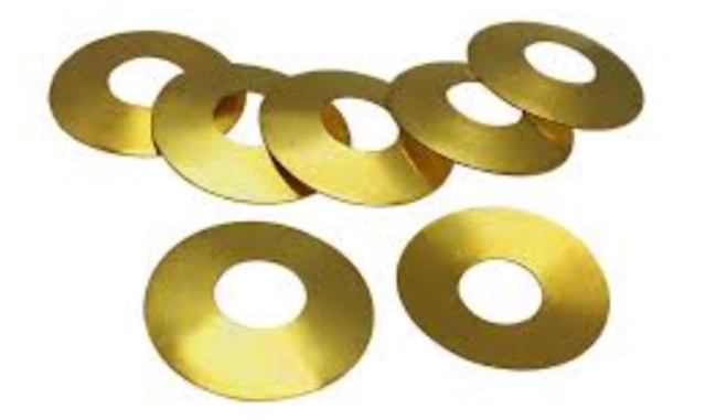 An image of seven golden beleville spring washers characterized by a slightly cupped shape