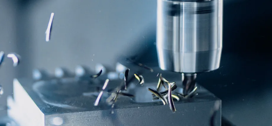 CNC milling on a rectangular part with tool and chips