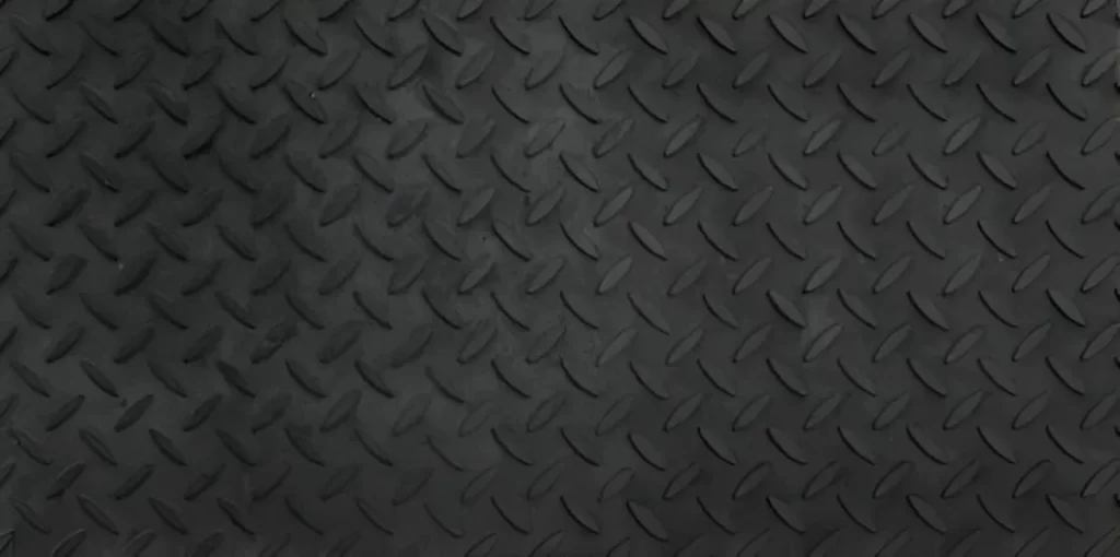 The image shows a black checkered pattern steel plate.