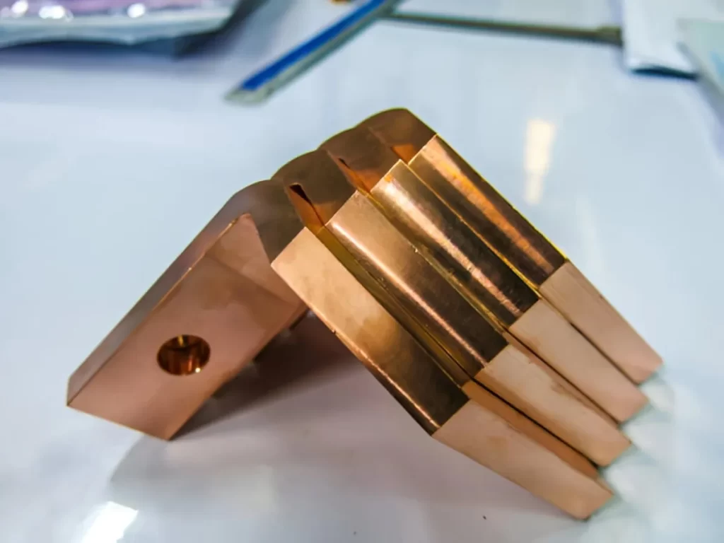 The image shows copper-plated parts displayed neatly in a group.
