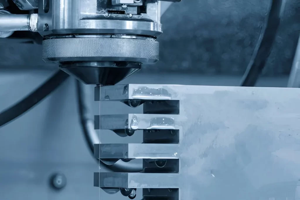 The image shows a Kovar alloy component being machined using EDM in a workshop setting.