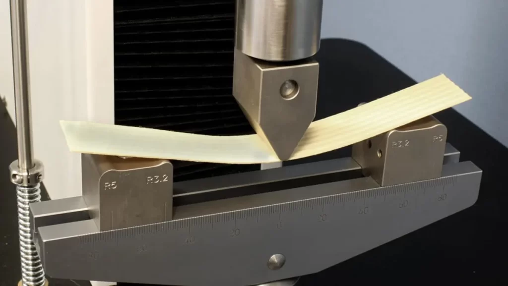 Material sample undergoing a three-point bend test.