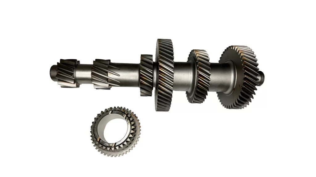 The image shows a gear transmission component created using the step turning process. The component features multiple stepped diameters along a shaft.