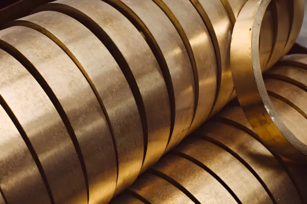 The image shows uniform anodized brass metal rings, neatly arranged.