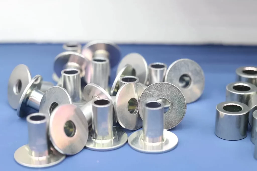 The image shows a bulk collection of parts with zinc plating.