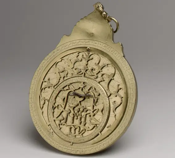 A circular brass plate with intricate decorations 
