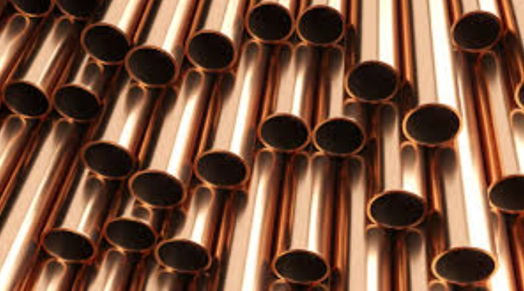 Red colored tubes of copper metal arranged neatly