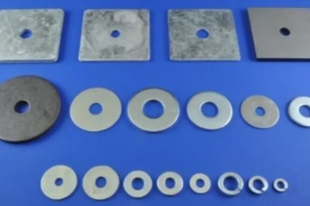An image of square and round flat washer of different sizes placed on a sky blue surface