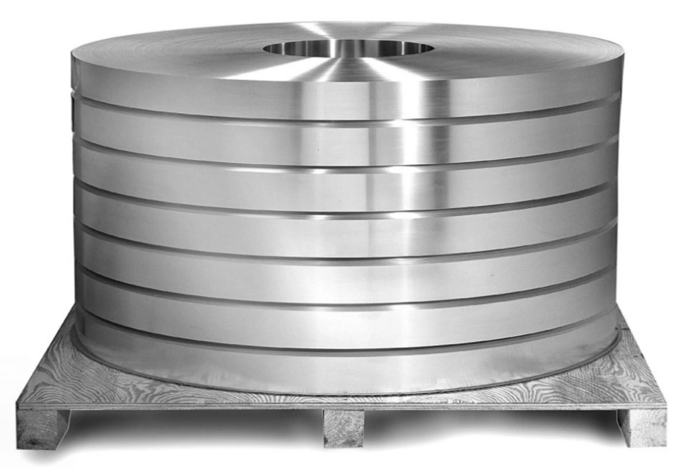 A smooth, round CNC-machined aluminum 5052 part placed on a wooden platform