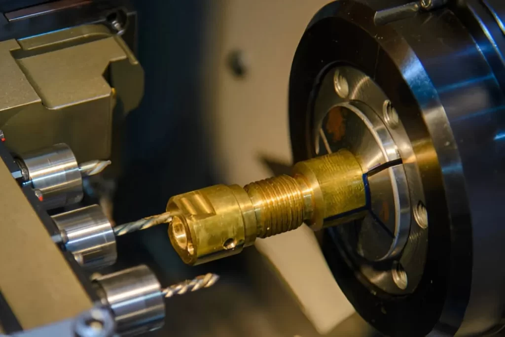 Close-up of brass part being machined using Swiss CNC equipment.
