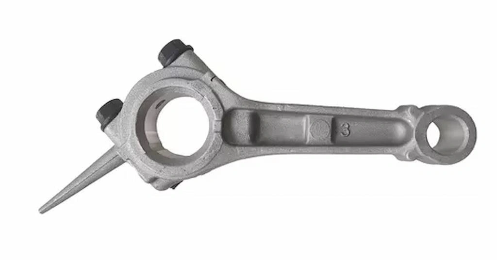 An image of a connecting rod just after being removed from the die casting mold. 